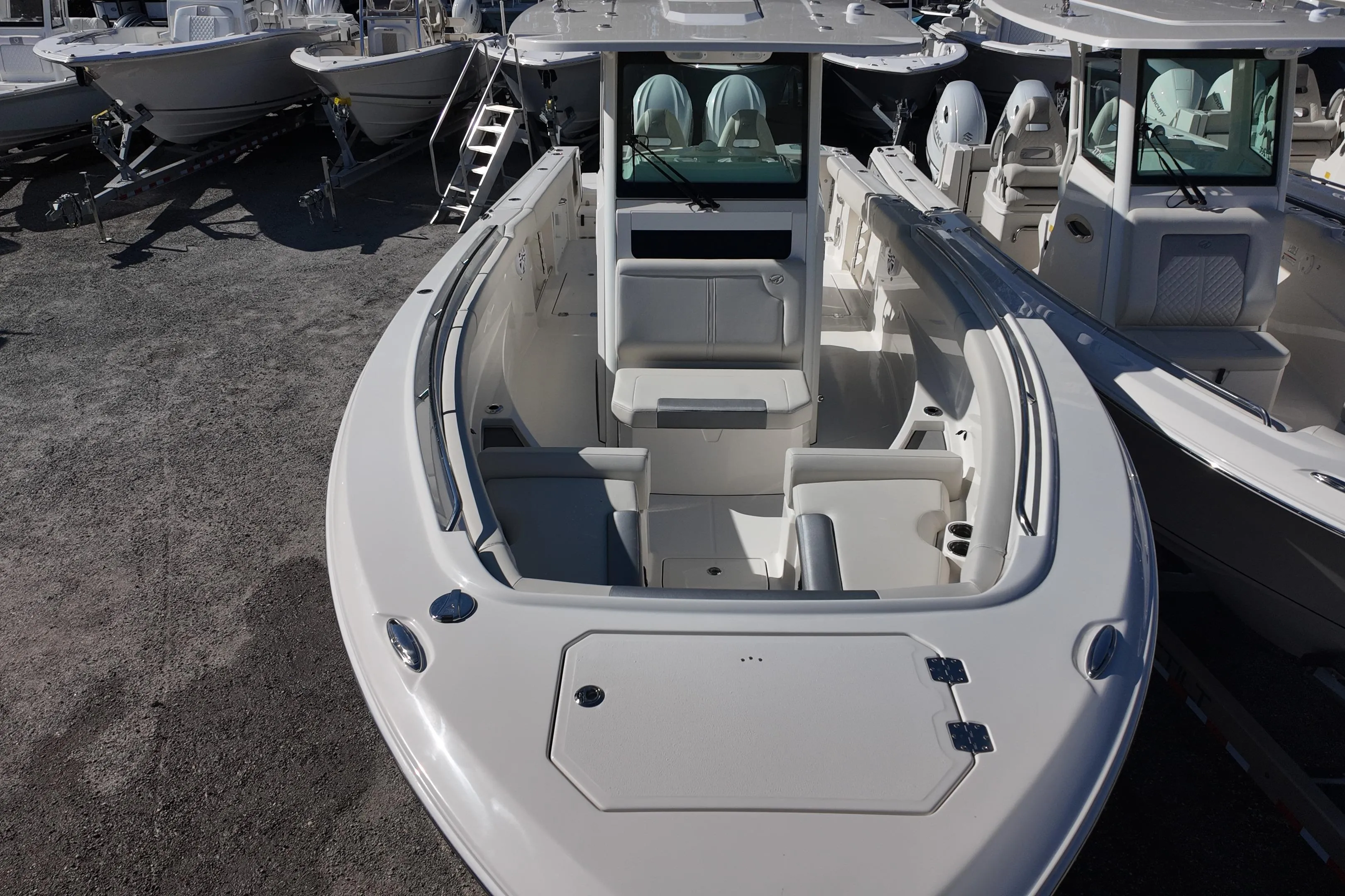 2026 Sailfish 312 CC boat, spacious deck, modern design, parked among other boats.