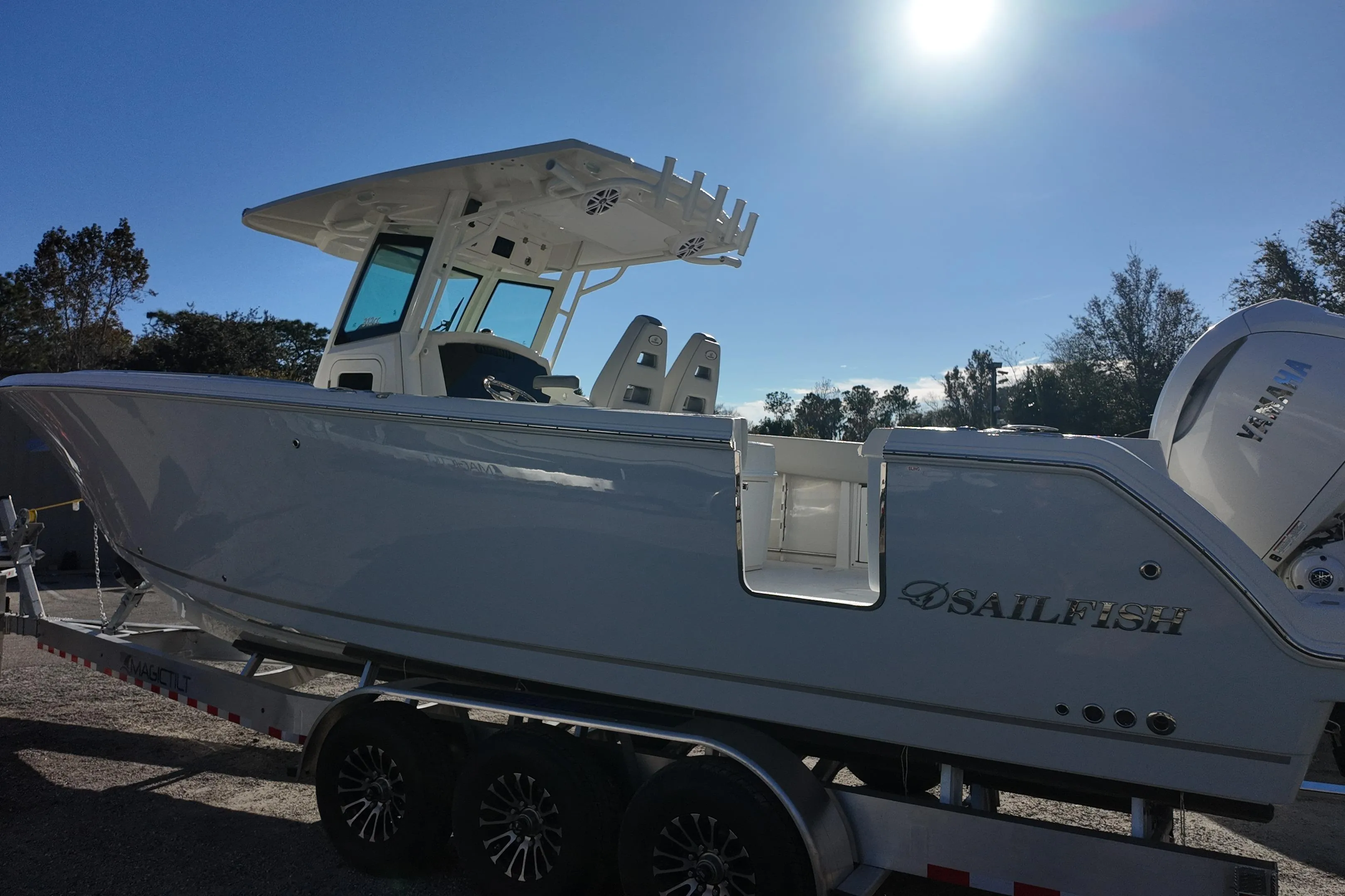 2026 Sailfish 312 CC boat on trailer under bright sun.