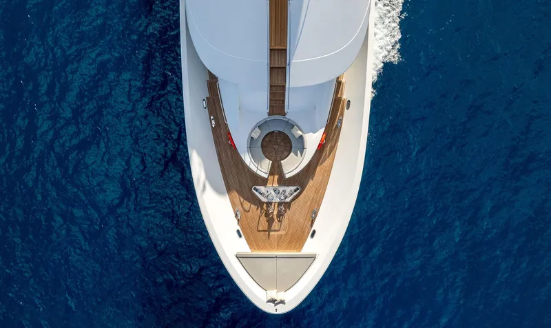 Antares Yacht Photos Pics Aerial view of 2008 Westport 130 yacht cruising on blue ocean.