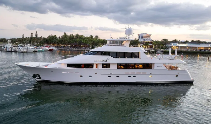 Antares Yacht Photos Pics Luxury 2008 Westport 130 yacht docked in a serene marina at sunset.