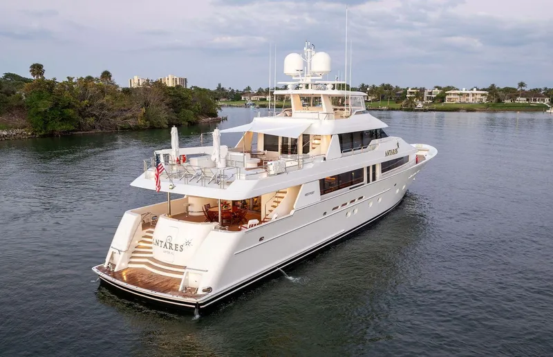 Antares Yacht Photos Pics Luxury 2008 Westport 130 yacht cruising on a serene waterway.