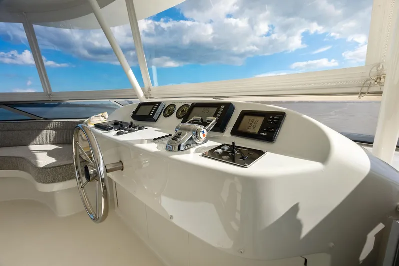 Antares Yacht Photos Pics Helm station of 2008 Westport 130 yacht with navigation instruments and steering wheel.