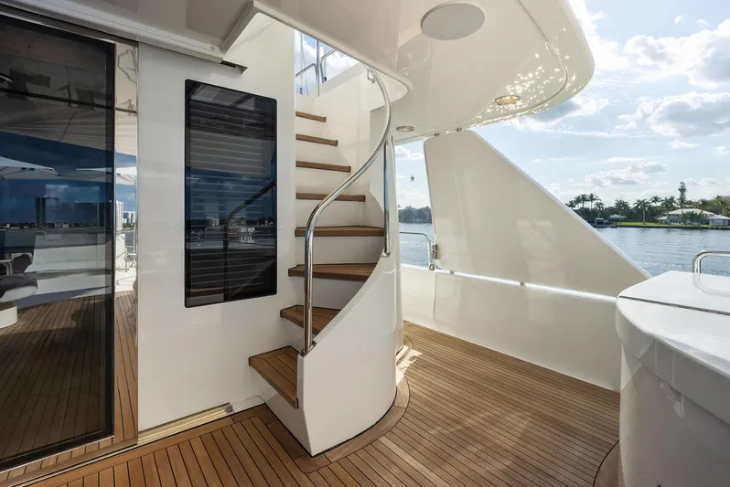 Antares Yacht Photos Pics Luxury yacht Westport 130, 2008 model, featuring elegant wooden deck and spiral staircase.
