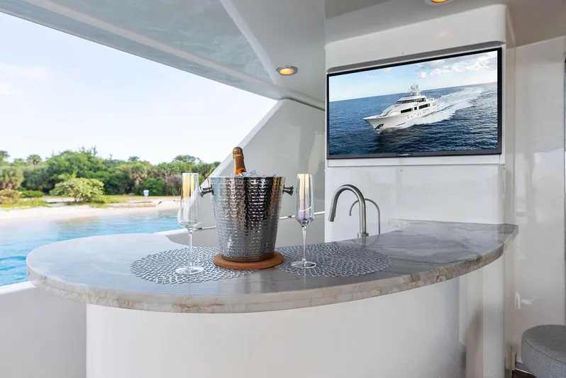 Antares Yacht Photos Pics Luxury yacht bar area with champagne, glasses, and ocean view; Westport 130, 2008 model.