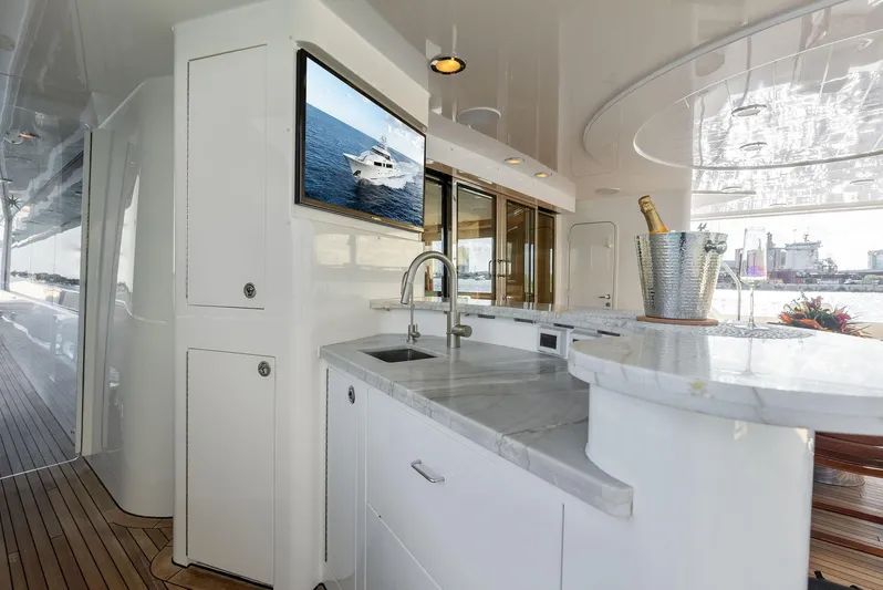 Antares Yacht Photos Pics Luxurious 2008 Westport 130 yacht interior with marble countertops and a mounted TV.