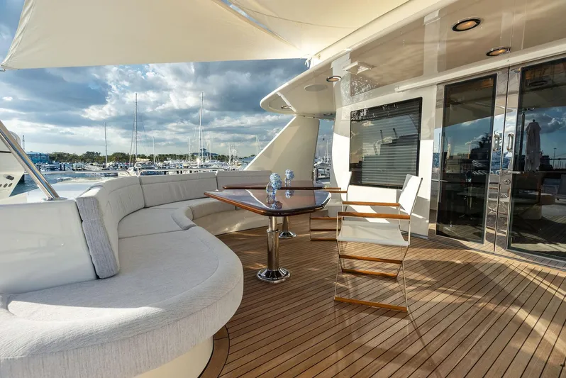 Antares Yacht Photos Pics Luxurious deck of 2008 Westport 130 yacht with seating and table, docked at marina.