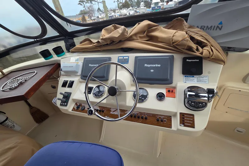  Yacht Photos Pics 2006 Mainship 40 Trawler helm with Raymarine electronics and steering wheel.