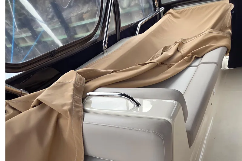  Yacht Photos Pics Interior of 2006 Mainship 40 Trawler with beige cover on seating area.