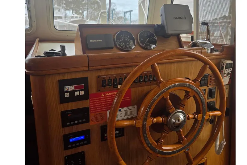  Yacht Photos Pics Wooden helm of 2006 Mainship 40 Trawler with navigation instruments and controls.
