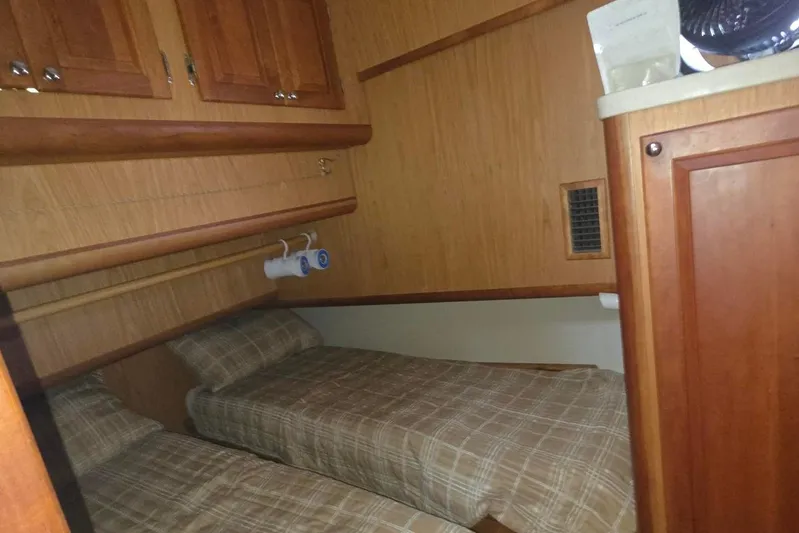  Yacht Photos Pics 2006 Mainship 40 Trawler cabin with twin beds and wooden cabinetry.