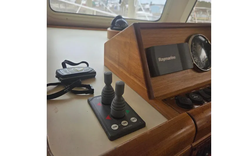  Yacht Photos Pics Control panel of 2006 Mainship 40 Trawler with Raymarine equipment and joystick controls.