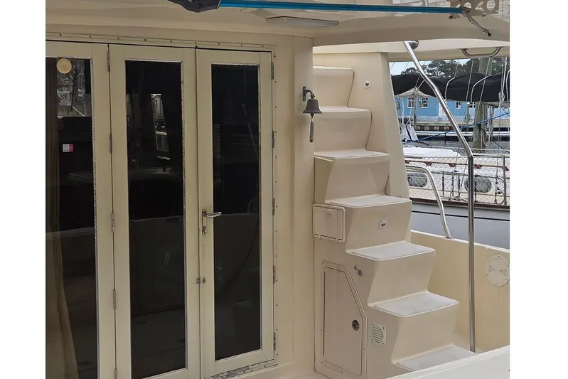  Yacht Photos Pics 2006 Mainship 40 Trawler with exterior stairs and glass doors, docked at marina.