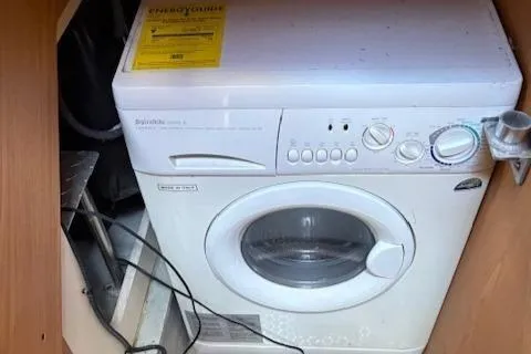  Yacht Photos Pics Washing machine inside 2006 Mainship 40 Trawler boat, compact laundry solution.