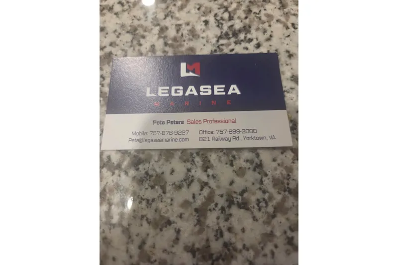  Yacht Photos Pics Legasea Marine business card on granite surface.