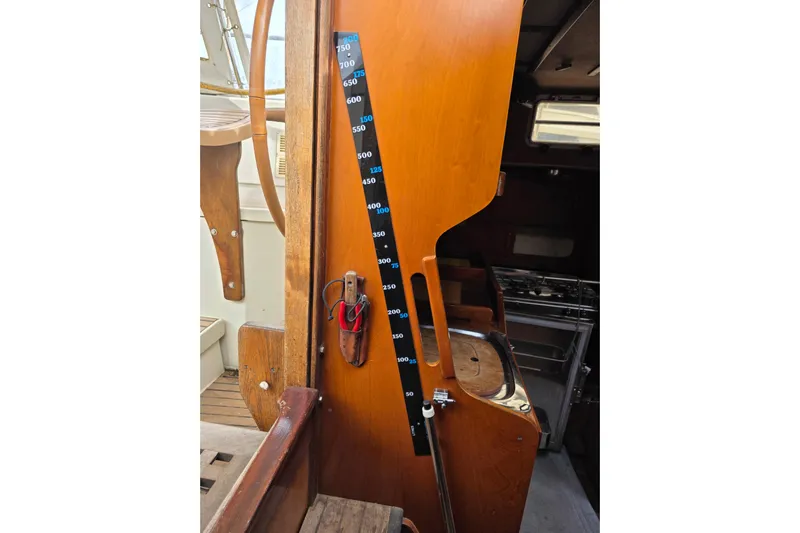 Fiasco Yacht Photos Pics Interior of 1988 Amel Sharki sailboat with wooden panel and measurement scale.