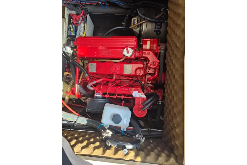 Fiasco Yacht Photos Pics Red engine in 1988 Amel Sharki boat, surrounded by cables and components.