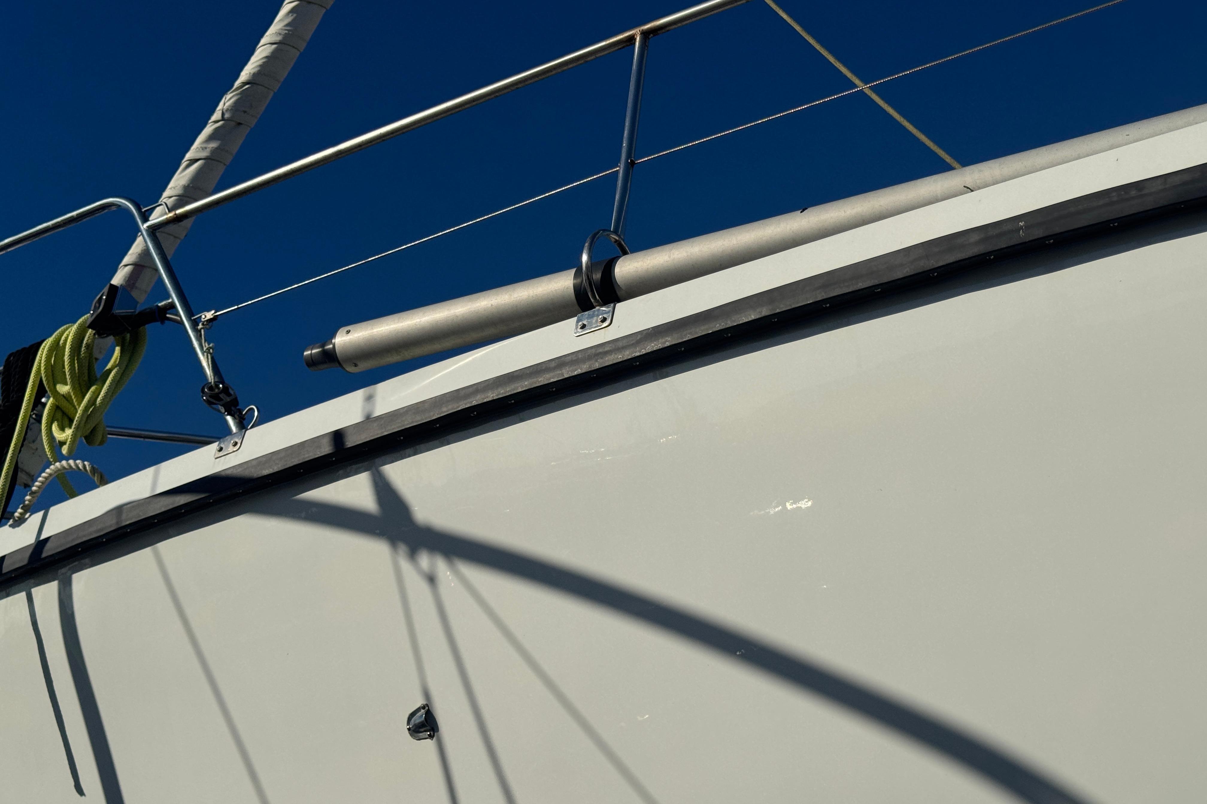 Close-up of 1988 Amel Sharki sailboat deck with railing and ropes.
