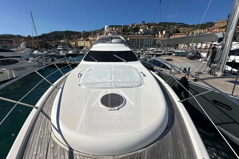  Yacht Photos Pics 2009 Azimut 68E yacht docked in a scenic marina with surrounding boats.