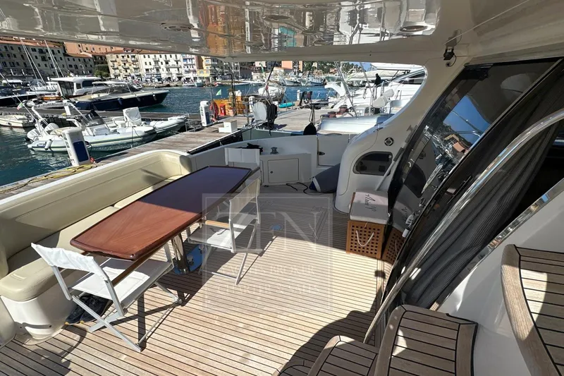  Yacht Photos Pics Luxurious 2009 Azimut 68E yacht deck with seating and table, docked at marina.