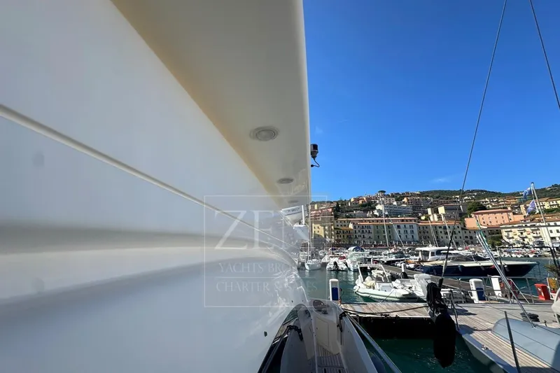  Yacht Photos Pics 2009 Azimut 68E yacht docked in a scenic marina with clear blue skies.