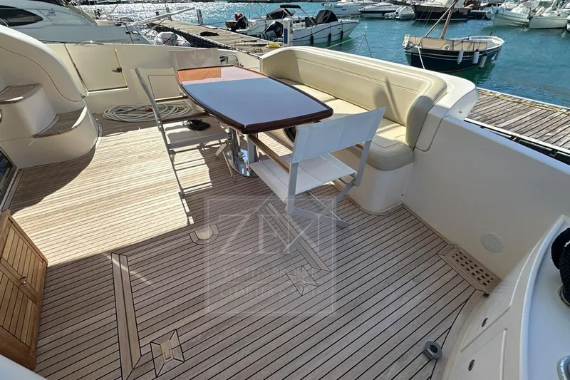  Yacht Photos Pics 2009 Azimut 68E yacht deck with seating and table, docked at marina.