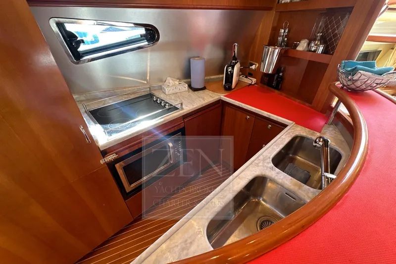  Yacht Photos Pics 2009 Azimut 68E yacht kitchen with stove, sink, and countertop.