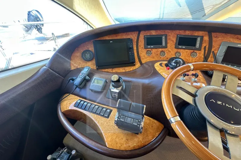  Yacht Photos Pics 2009 Azimut 68E yacht helm with advanced navigation controls and luxurious wood finish.
