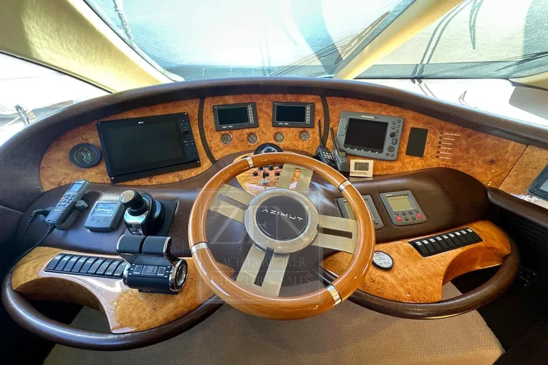  Yacht Photos Pics 2009 Azimut 68E yacht helm with advanced navigation controls and luxurious wood finish.