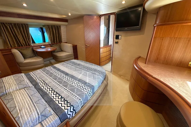  Yacht Photos Pics Luxurious 2009 Azimut 68E yacht bedroom with elegant wood finishes and patterned bedding.