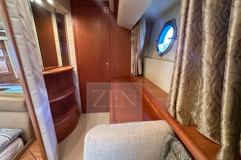  Yacht Photos Pics Luxurious interior of 2009 Azimut 68E yacht with elegant wood finishes and porthole window.