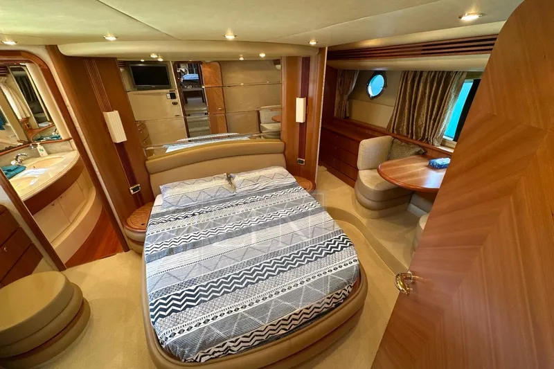  Yacht Photos Pics Luxurious 2009 Azimut 68E yacht bedroom with elegant decor and cozy seating area.