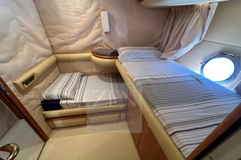  Yacht Photos Pics Cozy cabin interior of 2009 Azimut 68E yacht with twin beds and porthole.