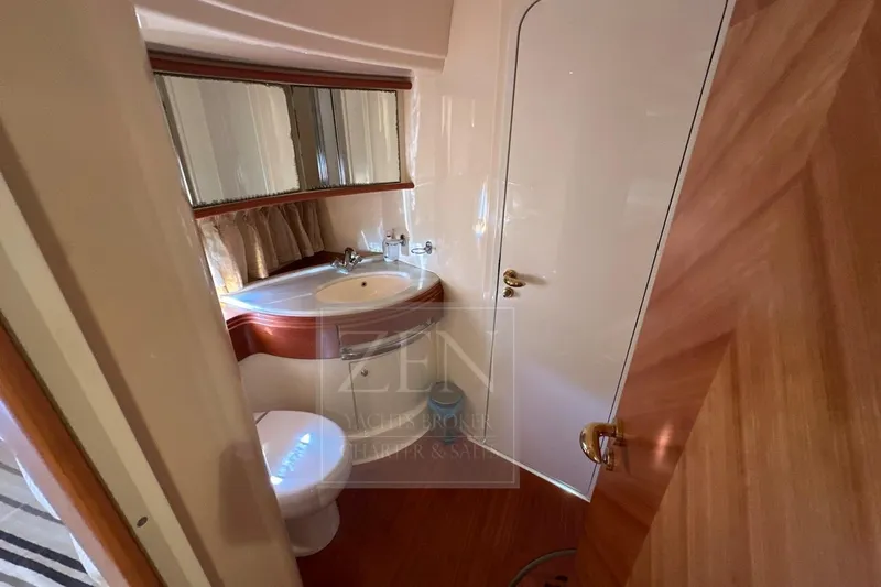  Yacht Photos Pics Luxurious bathroom interior of 2009 Azimut 68E yacht, featuring elegant wood finishes and modern fixtures.