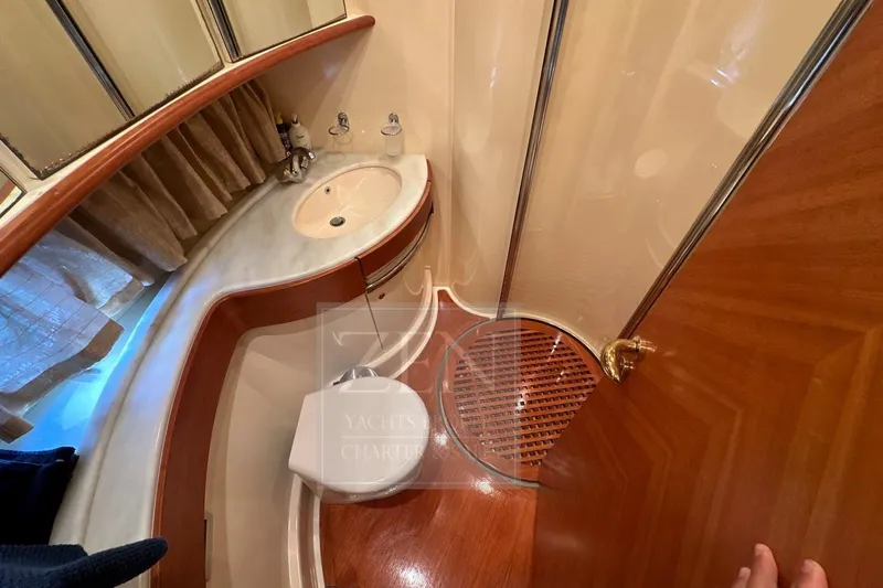  Yacht Photos Pics Luxurious bathroom interior of 2009 Azimut 68E yacht with elegant wood finishes.