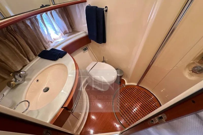  Yacht Photos Pics Luxurious bathroom in 2009 Azimut 68E yacht with elegant fixtures and wooden accents.