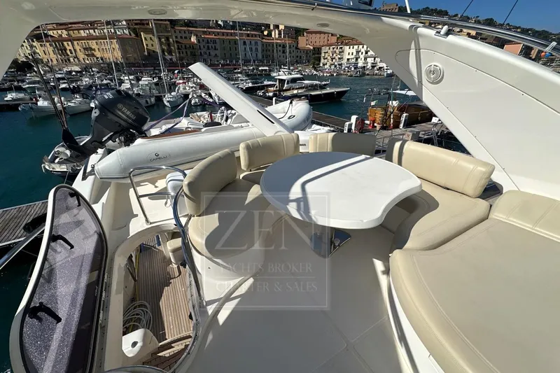  Yacht Photos Pics Luxurious 2009 Azimut 68E yacht with spacious deck seating in a scenic marina.