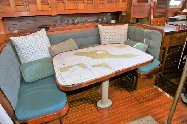 Spirit Yacht Photos Pics 1979 Roberts 54 yacht interior with cushioned seating and nautical map table.