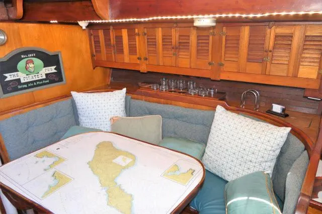 Spirit Yacht Photos Pics 1979 Roberts 54 yacht interior with cozy dining area and nautical map table.
