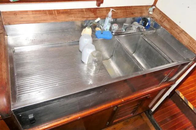 Spirit Yacht Photos Pics 1979 Roberts 54 stainless steel kitchen sink with dual basins and wooden cabinetry.