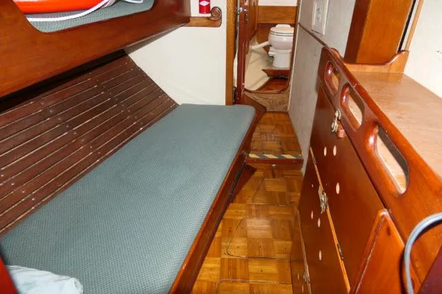 Spirit Yacht Photos Pics 1979 Roberts 54 interior cabin with wooden furnishings and a visible toilet.