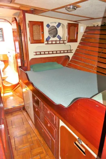Spirit Yacht Photos Pics Cozy cabin interior of a 1979 Roberts 54 sailboat with wooden furnishings.