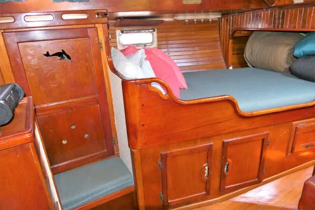 Spirit Yacht Photos Pics 1979 Roberts 54 boat interior with wooden cabinetry and cozy sleeping area.