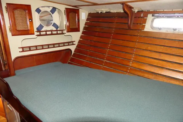 Spirit Yacht Photos Pics 1979 Roberts 54 boat cabin with wooden interior and bed.