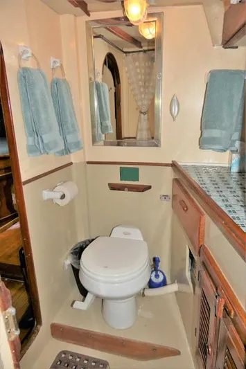 Spirit Yacht Photos Pics 1979 Roberts 54 boat bathroom with toilet, mirror, and towels.