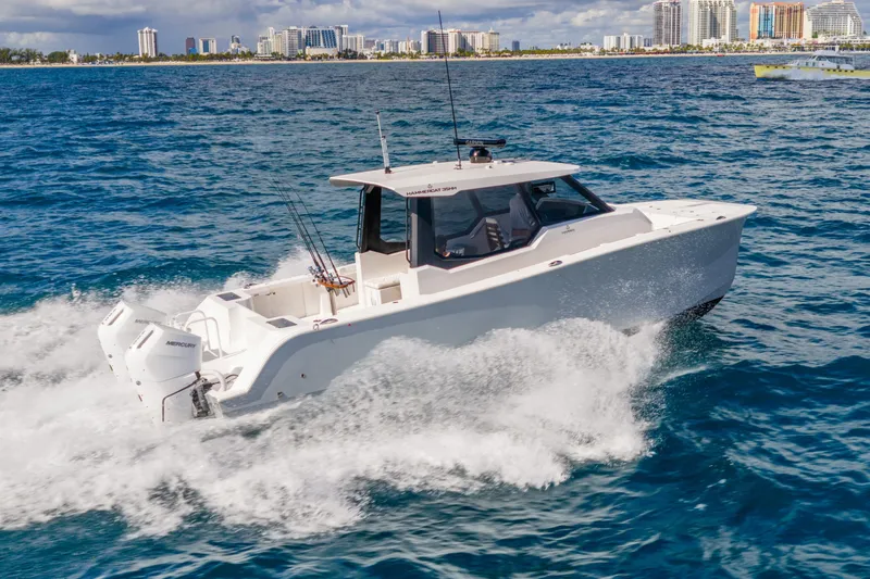  Yacht Photos Pics 2026 Hammer Yachts 35HH cruising on ocean near city skyline.