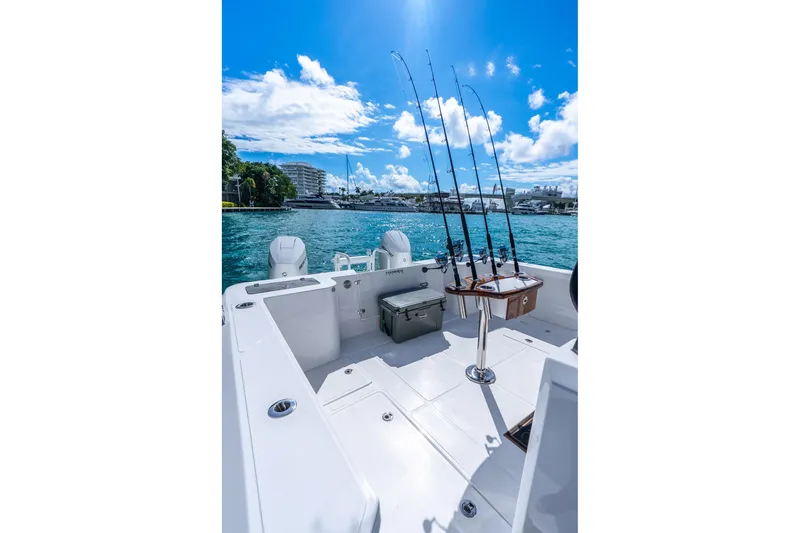  Yacht Photos Pics 2026 Hammer Yachts 35HH boat with fishing rods, docked in a scenic marina.