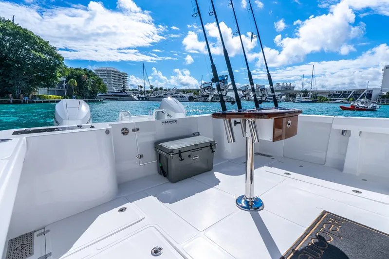 Yacht Photos Pics 2026 Hammer Yachts 35HH boat deck with fishing rods, cooler, and scenic marina view.