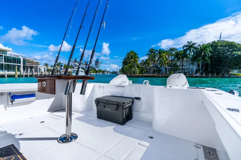  Yacht Photos Pics 2026 Hammer Yachts 35HH boat with fishing rods, docked by tropical waterfront.