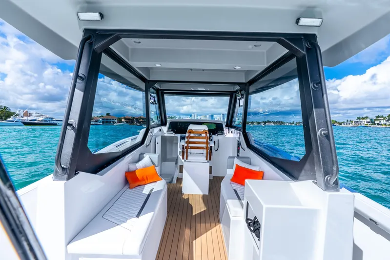  Yacht Photos Pics Luxurious 2026 Hammer Yachts 35HH interior with ocean view, featuring modern seating and vibrant cushions.