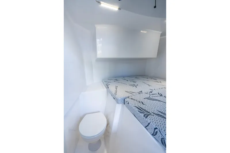  Yacht Photos Pics Interior of 2026 Hammer Yachts 35HH, featuring compact toilet and bed with patterned bedding.